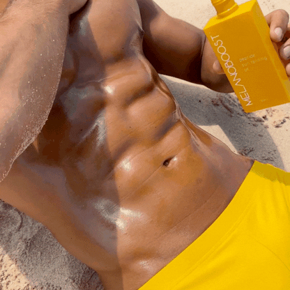 GIF_Guy_lying_on_beach_in_yellow_swimming_trunks_applying_Melanoboost_Peptide_Sun_Tan_Accelerator_Oil