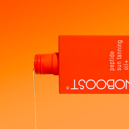 Orange_bottle_of_Melanoboost Peptide_Sun_Tanning_Oil_Bronzing_on_a_lighter_orange_background