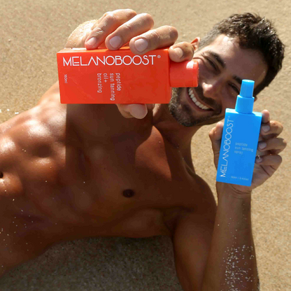 Tanned_man_lying_on_beach_holding_orange_and_aqua_Melanoboost_Peptide_Tan_accelerator_Sun_Tanning_Oil_and_spray