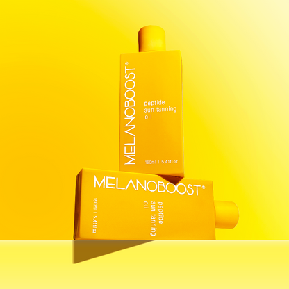 Two_stacked_bottles_of_Melanoboost_Peptide_Sun_Tan_Accelerator_Oil_against_yellow_background