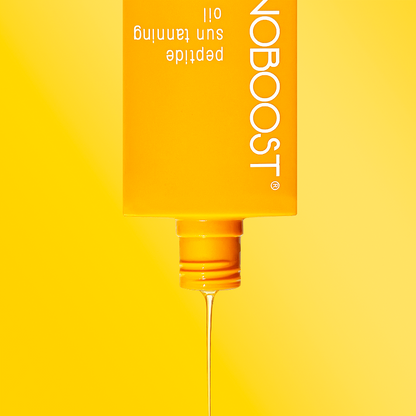 bottle_of_Melanoboost_Peptide_Sun_Tan_Accelerator_Oil_against_yellow_background