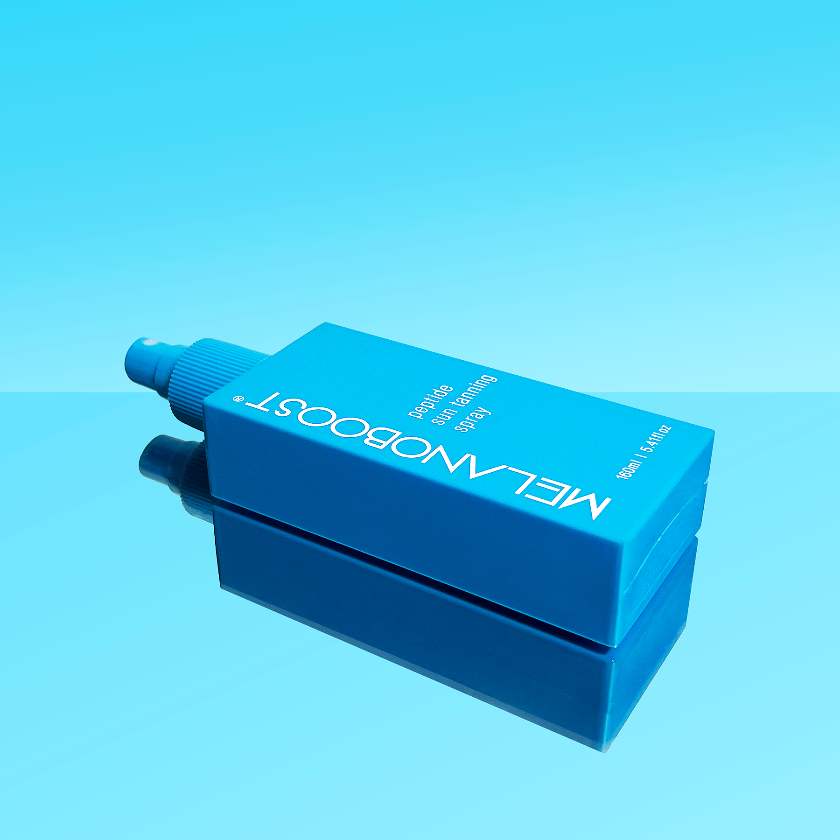 bottle_of_Melanoboost_Peptide_Sun_Tan_Accelerator_Spray_on_a_reflective_aqua_background