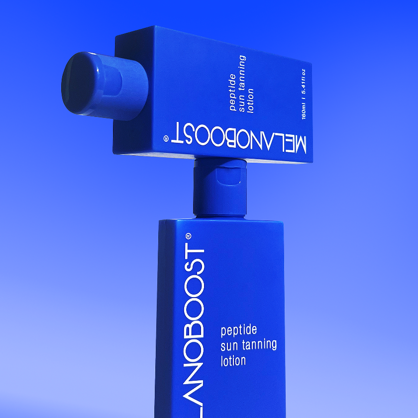 two_stacked_bottles_of_Melanoboost_Peptide_Sun_Tanning_Lotion_on_blue_background