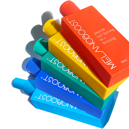 Five_colorful_bottles_of_MELANOBOOST_Peptide_Sun_Tan_Accelerator_Oils_Lotions_Spray_on_a_white_background