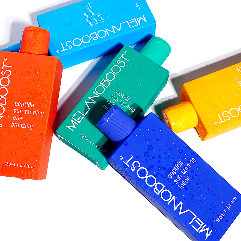Five_colorful_bottles_of_MELANOBOOST_Peptide_Sun_Tanning_Oils_Lotions_Spray_on_a_white_background